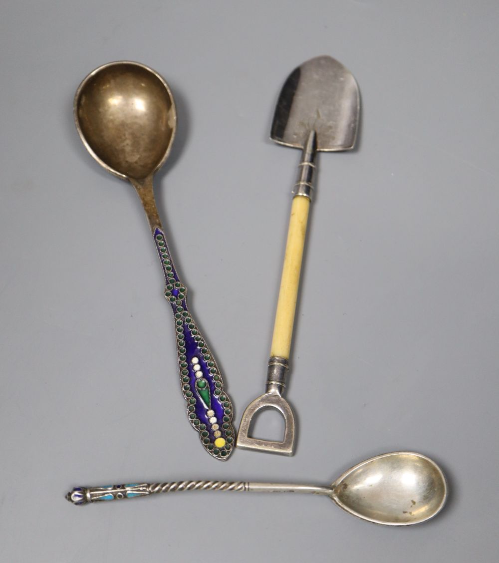 An early 20th century Russian 84 zolotnik and cloisonne enamel spoon, 13.2cm, a white metal and enamel spoon and a plated shovel